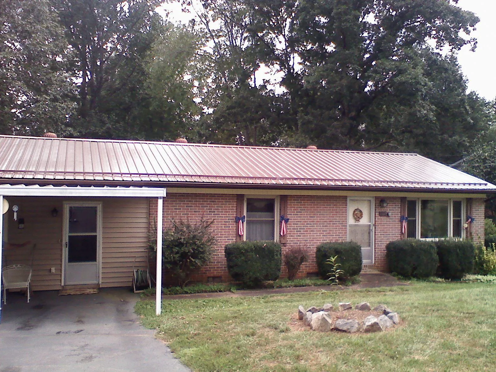 Bronze metal roof and carport on a brick ranch home — Roof Repair work by our crew in Thompsonville